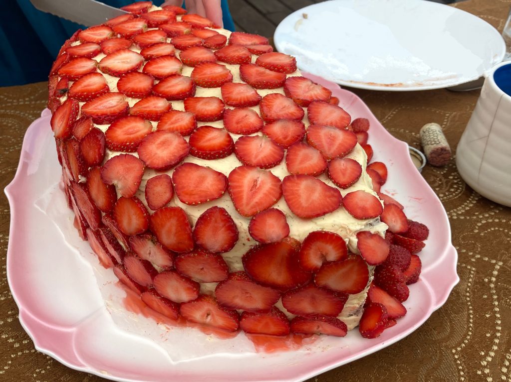 sliced strawberries on layer cake