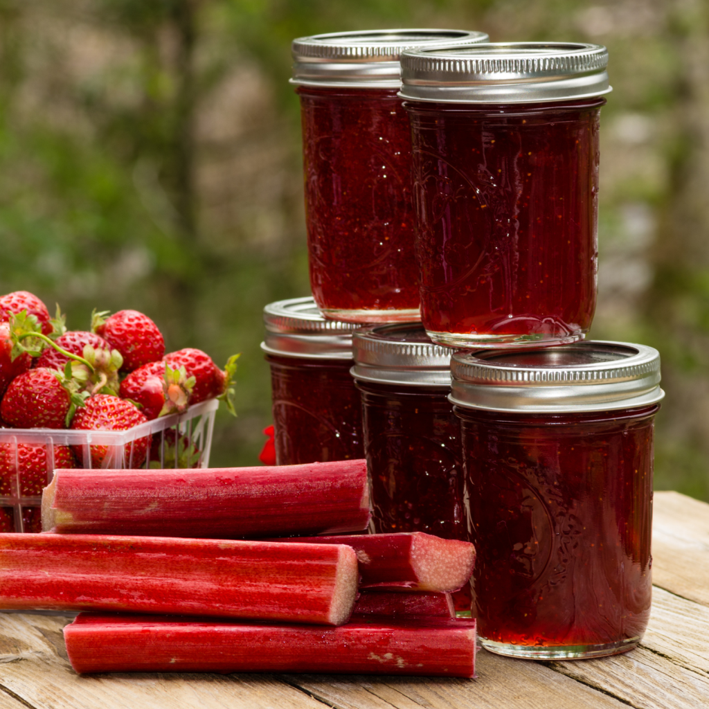 jars of Strawberry rhubarb preserves with whole strawberries and rhubarb stalks