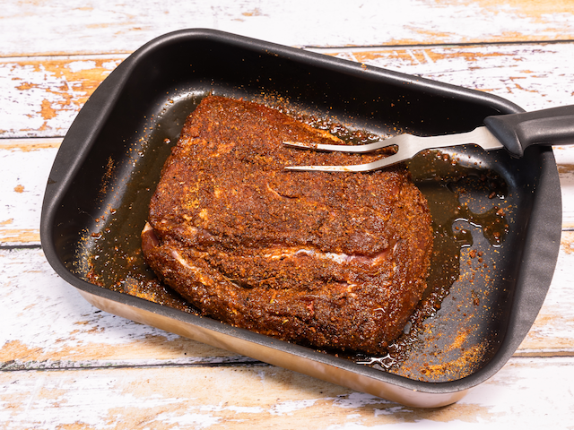 pork roast in pan covered with spices