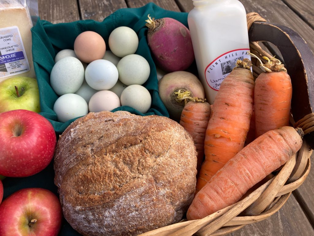 winter organic food basket with sourdough bread, grass fed dairy, apples, carrots can be found at Willow Haven Farm in New Tripoli PA